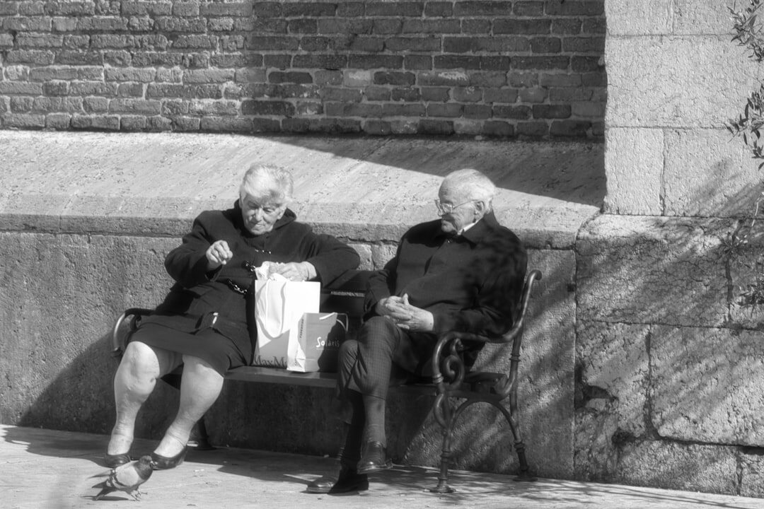 elderly couple reading documents
