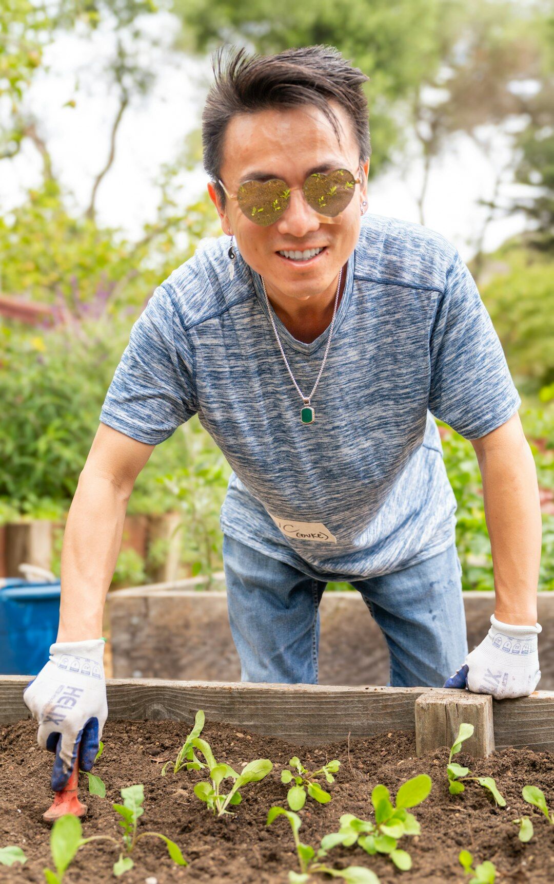Senior man tending to plants in a community garden