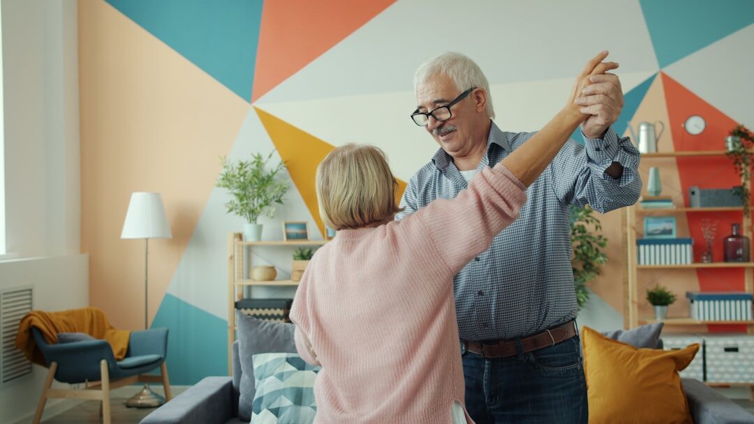 Senior couples dancing together in a community hall during a dance afternoon