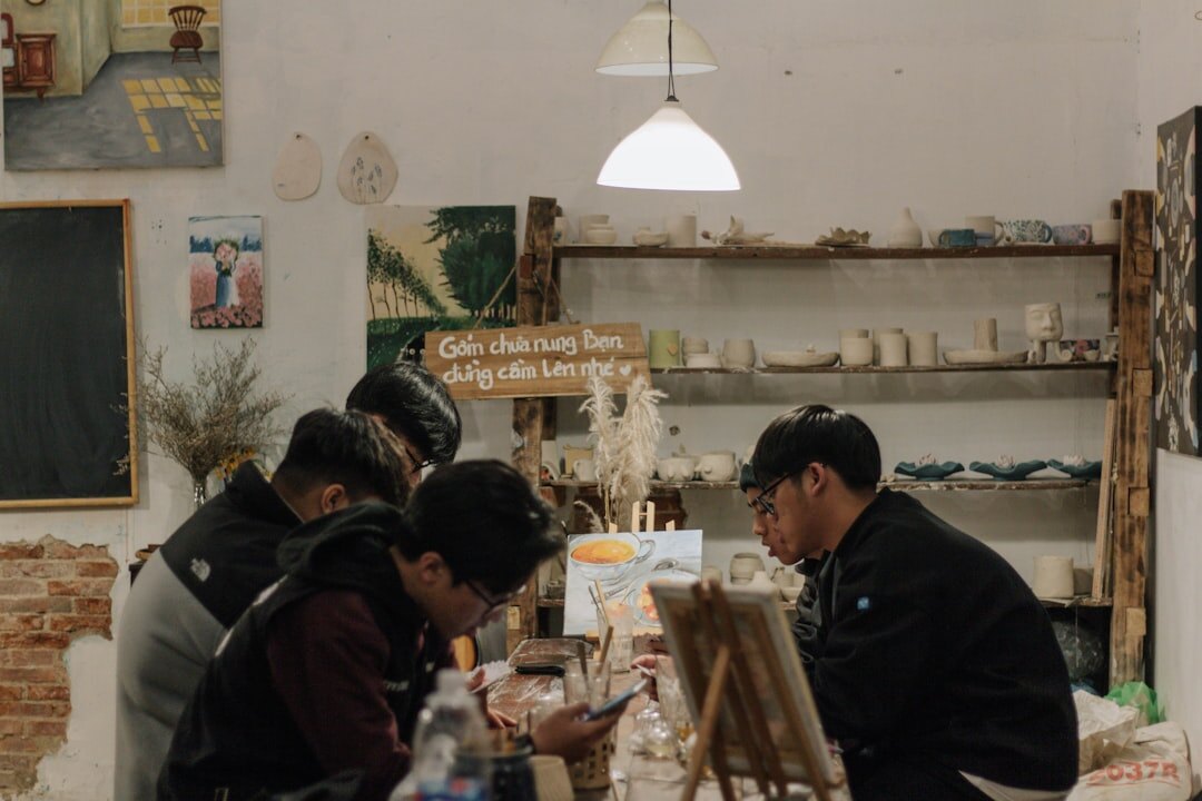 Seniors painting ceramics together at a creative workshop table
