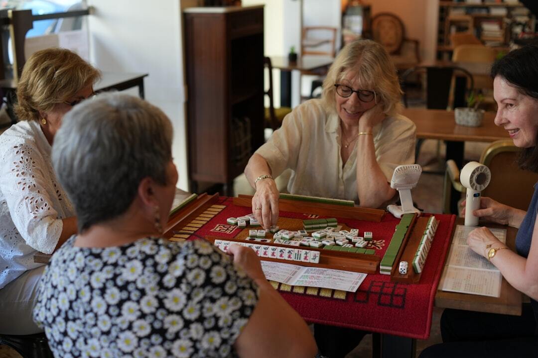 Seniors playing a board game together at a table