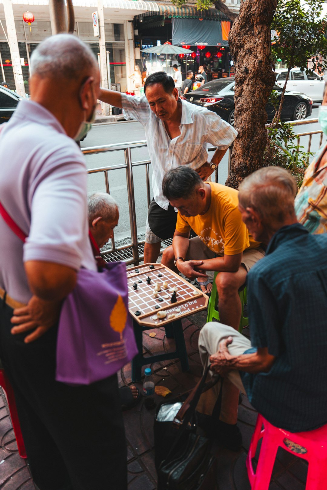 Seniors sharing food and conversation at an outdoor community gathering
